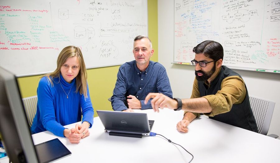 People meeting in office with white board